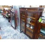 A 20th C. OAK CABINET WITH LEADED GLASS DOORS ENCLOSING FOUR SHELVES. W 9 x D 28 x H 143cms.