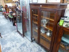 A 20th C. OAK CABINET WITH LEADED GLASS DOORS ENCLOSING FOUR SHELVES. W 9 x D 28 x H 143cms.