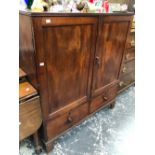 A 19th C. MAHOGANY CABINET, THE TWO DOORS ENCLOSING SHELVES ABOVE TWO SHORT DRAWERS AND THE