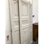 THREE WHITE PAINTED THREE PANELLED DOORS CARVED WITH FOLIAGE AND RECTANGLES, EACH. 210 x 61cms.