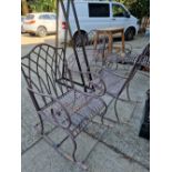 A FOUR PIECE PAINTED WROUGHT IRON PATIO SUITE CONSISTING OF TWO ROCKING ARM CHAIRS AND TWO SUN