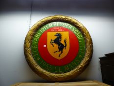 A LARGE PAINTED GILT WREATH COMMEMORATING FERRARIS PARTICIPATION IN THE 1955 LE MANS COMPETITION.