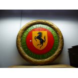 A LARGE PAINTED GILT WREATH COMMEMORATING FERRARIS PARTICIPATION IN THE 1955 LE MANS COMPETITION.