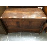 AN 18th C. OAK COFFER WITH THE THREE PANELLED FRONT ABOVE BRACKET FEET, THE INTERIOR NOW WITH
