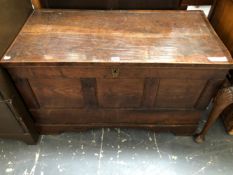 AN 18th C. OAK COFFER WITH THE THREE PANELLED FRONT ABOVE BRACKET FEET, THE INTERIOR NOW WITH