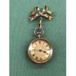 A CONTINENTAL 14ct GOLD LADIES FOB WATCH WITH A 9ct GOLD BOW BROOCH FITTING. WINDS AND RUNS, NO