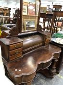 A MAHOGANY DUCHESSE DRESSING TABLE WITH ROUND ARCH MIRROR BACK, THE FLUTED LEGS ENDING IN MASSIVE