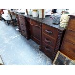 A LATE VICTORIAN MAHOGANY SIDEBOARD, THE CENTRAL DRAWER OVER A CUPBOARD RECESSED BETWEEN SPIRAL