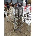 A PAINTED WROUGHT IRON THREE TIER CANDELABRA