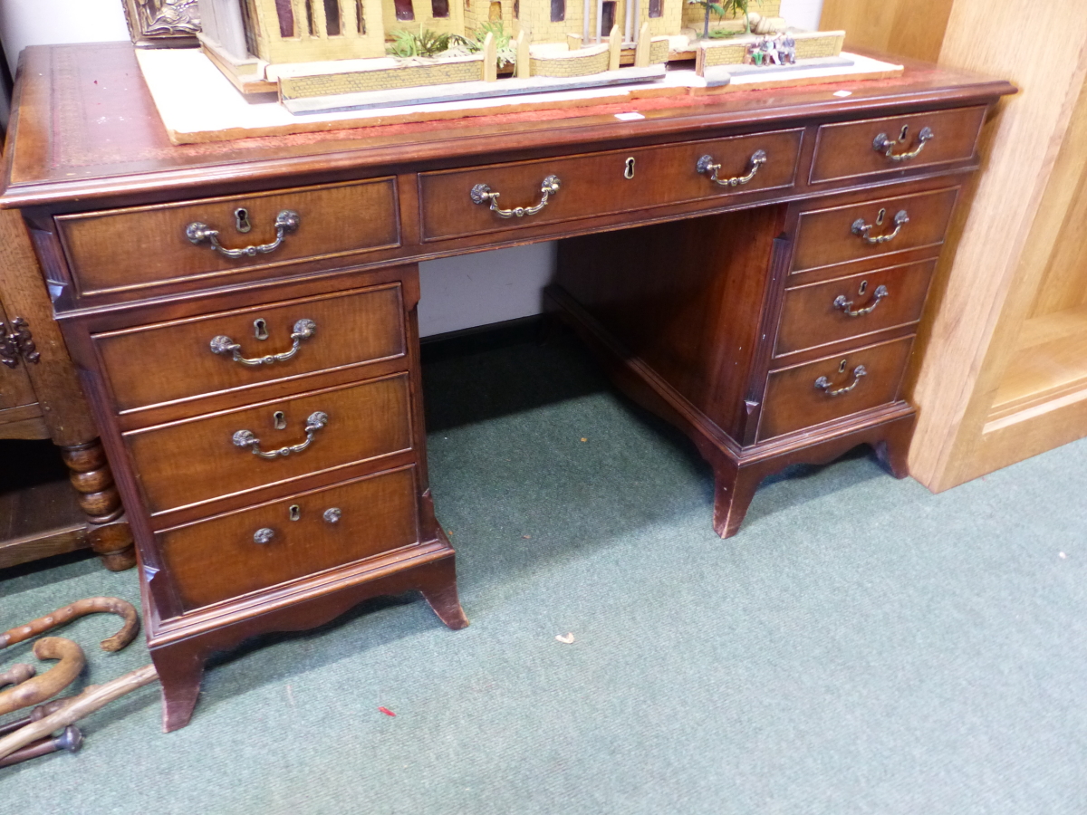 A 20th C. MAHOGANY PEDESTAL DESK, THE RED LEATHER INSET TOP OVER A KNEEHOLE DRAWER FLANKED BY