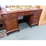 A 20th C. MAHOGANY PEDESTAL DESK, THE RED LEATHER INSET TOP OVER A KNEEHOLE DRAWER FLANKED BY