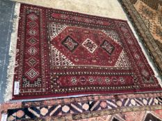 A PERSIAN DESIGN MACHINE MADE RUG 228 x 167cms