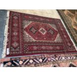 A PERSIAN DESIGN MACHINE MADE RUG 228 x 167cms