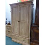 A MODERN OAK WARDROBE WITH THE TWO DOORS OVER TWO SHORT DRAWERS. W 107 x D 63 x H 195cms.