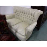 A TWO SEAT SETTEE BUTTON UPHOLSTERED IN PALE GREEN DAMASK. W 115 x D 76 x H 80cms.