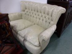 A TWO SEAT SETTEE BUTTON UPHOLSTERED IN PALE GREEN DAMASK. W 115 x D 76 x H 80cms.