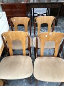 A SET OF FOUR LATE 20th C. CHAIRS, THE BLOND PLYWOOD BACKS BETWEEN BRASS TOPPED CYLINDRICAL POLES