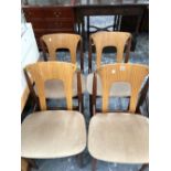 A SET OF FOUR LATE 20th C. CHAIRS, THE BLOND PLYWOOD BACKS BETWEEN BRASS TOPPED CYLINDRICAL POLES