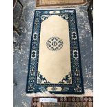 A GOOD QUALITY CHINESE SMALL RUG TOGETHER WITH A ORIENTAL RUG CAUCAUSIAN DESIGN.