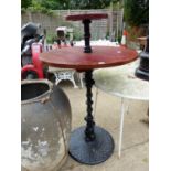 A REPRODUCTION DUMB WAITER ON PAINTED CAST IRON STAND