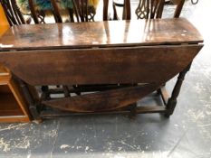 AN 18th C. OAK OVAL FLAP TOP TABLE WITH A DRAWER TO ONE NARROW END ABOVE BALUSTER LEGS JOINED BY