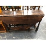 AN 18th C. OAK OVAL FLAP TOP TABLE WITH A DRAWER TO ONE NARROW END ABOVE BALUSTER LEGS JOINED BY