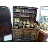 A 20th C. OAK DRESSER, THE ENCLOSED THREE SHELF BACK OVER CENTRAL THREE DRAWERS TO THE BASE