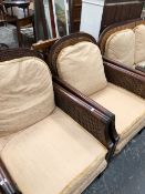 A 20th C. CANED MAHOGANY THREE PIECE SUITE, THE ARCHED TOP RAILS CARVED WITH ROSETTES FLANKING BY