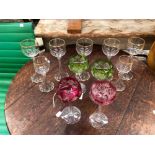 A COLLECTION OF LONG STEM GLASSES, SOME BURGUNDY AND GREEN TINTED
