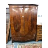 AN 18th C. OAK ARMOIRE (DISMANTLED) TOGETHER WITH A 20th C. MAHOGANY BOW FRONT WARDROBE, THE DOORS