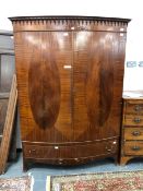 AN 18th C. OAK ARMOIRE (DISMANTLED) TOGETHER WITH A 20th C. MAHOGANY BOW FRONT WARDROBE, THE DOORS