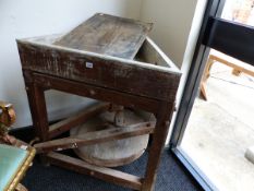 A PINE POTTERS WHEEL TURNED BY FOOT, THE TURNTABLE WITHIN A TRIANGULAR LEAD LINED BASIN. W 90 x H