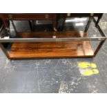 A GLASS TOPPED CHROME COFFEE TABLE WITH ROSEWOOD UNDERTIER. W 121 x D 56 x H 40cms.