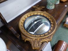 A MODERN EAGLE TOPPED CONVEX MIRROR, THE FRAME WITH BEADS OUTSIDE THE REEDED BLACK SLIP. Dia. 41 x H