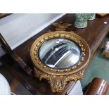 A MODERN EAGLE TOPPED CONVEX MIRROR, THE FRAME WITH BEADS OUTSIDE THE REEDED BLACK SLIP. Dia. 41 x H