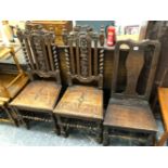 A PAIR OF 17th C. STYLE OAK CHAIRS WITH GRAPE CARVED SPLATS BETWEEN BARLEY TWIST COLUMNS TOGETHER