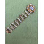 AN ANTIQUE CHALCEDONY BRACELET. THE THREE PANEL LINKS OF CABOCHON STONES JOINED BY BEADED LINKS,