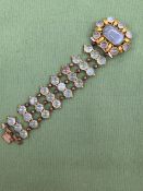 AN ANTIQUE CHALCEDONY BRACELET. THE THREE PANEL LINKS OF CABOCHON STONES JOINED BY BEADED LINKS,
