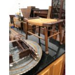 A RUSH SEATED STOOL, TWO MIDDLE EASTERN METAL DISHES, ONE WITH A FOLDING STAND