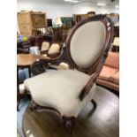 A VICTORIAN MAHOGANY SHOW FRAME ARMCHAIR, THE OVAL BACK CRESTED BY FLOWERS, THE ARMS PIERCED AND