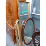 TWO GILT FRAMED MIRRORS. TOGETHER WITH AN OVAL MAHOGANY FRAMED WALL MIRROR (3)