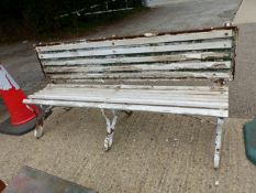 AN ANTIQUE PAINTED GARDEN BENCH WITH CAST IRON SUPPORTS AND UNUSUAL FOLDING BACK REST