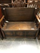 A 20th C. ROBSON OAK MONKS CHEST, THE ARMS SUPPORTED ON BALUSTER COLUMNS, THE COFFER SEAT WITH THREE