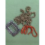 A GRADUATED ROW OF CORAL BEADS, A HALLMARKED SILVER BUCKLE, AND APLATED LONG GUARD STYLE CHAIN.