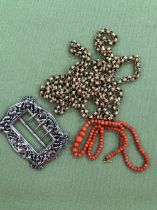 A GRADUATED ROW OF CORAL BEADS, A HALLMARKED SILVER BUCKLE, AND APLATED LONG GUARD STYLE CHAIN.