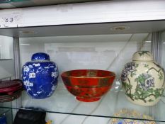 A CHINESE BLUE AND WHITE GINGER JAR, A CHINOISERIE GINGER JAR LAMP BASE, TWO WOOD STANDS AND A RED