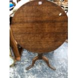 A GEORGE III OAK TILT TOP CIRCULAR TABLE SUPPORTED ON A BALUSTER COLUMN AND TRIPOD. Dia. 80 x H