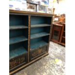 A 19th C. EBONISED OPEN BOOK CASE GILT WITH FOLIAGE BANDS BETWEEN TO TWO BANKS OF THREE BLUE SHELVES
