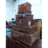 A QUANTITY OF VINTAGE LEATHER SUITCASES.