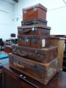 A QUANTITY OF VINTAGE LEATHER SUITCASES.